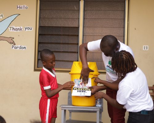 pasting a sticker on a yellow bin for waste segregation