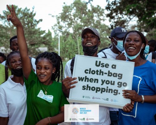 students holding placard advocating for plastic waste management